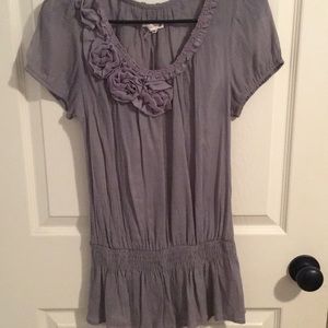 Grey top with flower on the left side of the neck